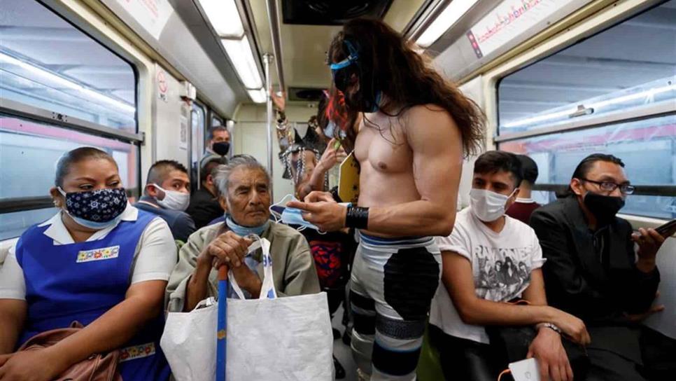 Luchadores mexicanos reparten cubrebocas en el metro de la CDMX