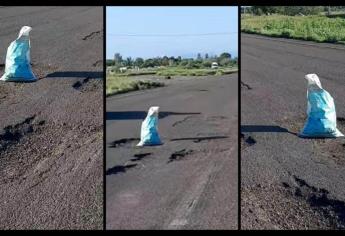 Colocan costales en la carretera México 15 para alertar de megabaches